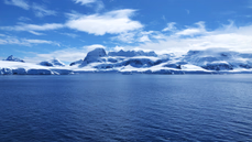 A frigid coast featuring distant mountainscapes